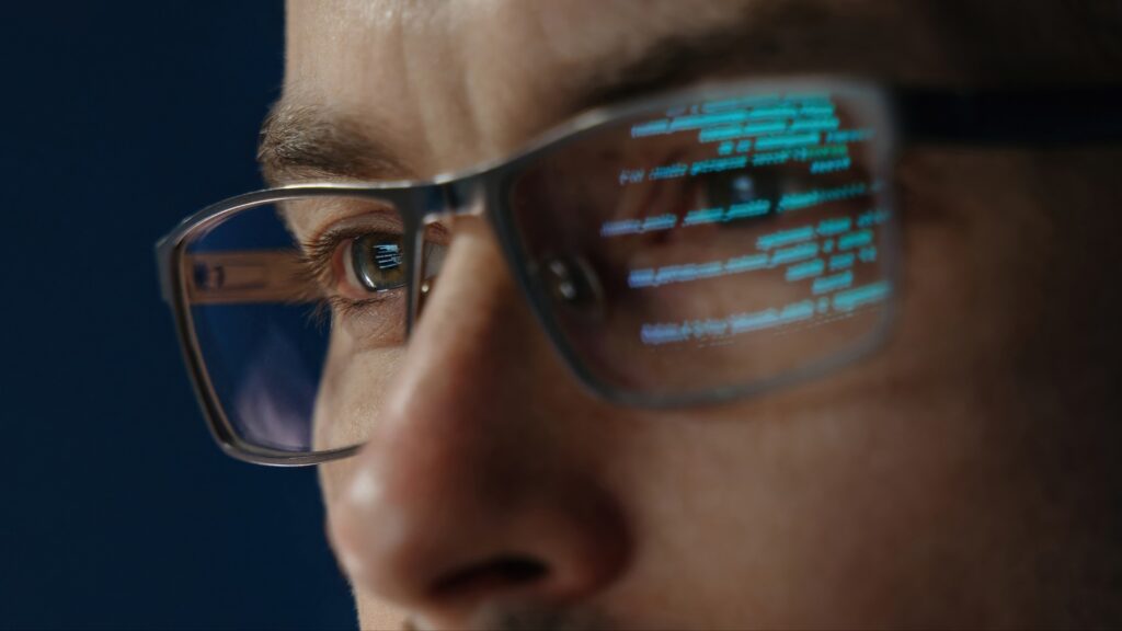 Close up of data scientist face is closely examines data